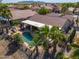Aerial view of a home with a pool, covered patio, and view of surrounding neighborhood at 80 S Laura Ln, Casa Grande, AZ 85194