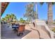 Stunning backyard with pool, waterfall, lush landscaping, and outdoor kitchen at 80 S Laura Ln, Casa Grande, AZ 85194