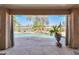 Backyard view through sliding doors overlooking the pool, waterfall, and golf course beyond at 80 S Laura Ln, Casa Grande, AZ 85194