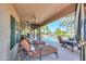 Relaxing backyard oasis with lounge chairs, outdoor television, and a view of the pool at 80 S Laura Ln, Casa Grande, AZ 85194