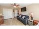 Bedroom includes a comfortable sofa, closet and a mounted television at 80 S Laura Ln, Casa Grande, AZ 85194