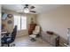 Cozy bedroom featuring wood-look flooring, a ceiling fan, a window, and a neutral color palette at 80 S Laura Ln, Casa Grande, AZ 85194
