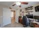 Bedroom features a ceiling fan, and a desk area with decorative shelving at 80 S Laura Ln, Casa Grande, AZ 85194