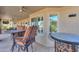 Inviting covered patio with seating, ceiling fans, and outdoor kitchen area, ideal for entertaining at 80 S Laura Ln, Casa Grande, AZ 85194