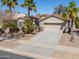 Charming single-story home with a two-car garage, desert landscaping, and a red tile roof at 80 S Laura Ln, Casa Grande, AZ 85194