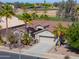 View of home's exterior; desert landscaping, and proximity to golf course at 80 S Laura Ln, Casa Grande, AZ 85194