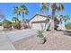 Attractive single-Gathering home with a two-car garage, stone-accented courtyard, and desert landscaping at 80 S Laura Ln, Casa Grande, AZ 85194