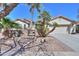 Inviting single-Gathering home featuring a two-car garage and a gated courtyard with mature palm trees at 80 S Laura Ln, Casa Grande, AZ 85194