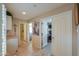 Bright hallway with tile flooring, white doors, neutral walls, and views into multiple rooms at 80 S Laura Ln, Casa Grande, AZ 85194