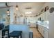 Bright kitchen with stainless steel appliances, breakfast bar with granite countertops and designer lighting at 80 S Laura Ln, Casa Grande, AZ 85194