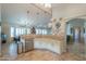 Open kitchen with stainless steel appliances, light cabinetry, and access to additional living spaces at 80 S Laura Ln, Casa Grande, AZ 85194