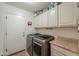 Functional laundry room with modern appliances and ample storage space at 80 S Laura Ln, Casa Grande, AZ 85194