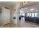 Open-concept living room with tile flooring, archways, and seamlessly connected dining area at 80 S Laura Ln, Casa Grande, AZ 85194