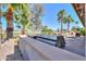 Outdoor kitchen area with grill, countertop, and view of the backyard pool and golf course at 80 S Laura Ln, Casa Grande, AZ 85194