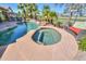 Backyard pool and spa with a rock waterfall feature and lush landscaping at 80 S Laura Ln, Casa Grande, AZ 85194