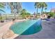 Backyard pool and spa surrounded by lush landscaping and mature palm trees at 80 S Laura Ln, Casa Grande, AZ 85194