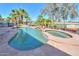 Backyard pool and spa surrounded by lush landscaping and outdoor kitchen at 80 S Laura Ln, Casa Grande, AZ 85194
