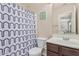 Cozy bathroom featuring a vanity and shower with decorative shower curtain at 914 E Pedro Rd, Phoenix, AZ 85042