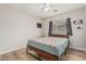 Comfortable bedroom featuring wood floors, a ceiling fan, and a window for natural light at 914 E Pedro Rd, Phoenix, AZ 85042
