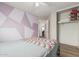 Cozy bedroom featuring a colorful accent wall and an open closet for easy access at 914 E Pedro Rd, Phoenix, AZ 85042