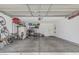 Spacious garage with storage, bikes, and overhead door, providing ample room for vehicles and organization at 914 E Pedro Rd, Phoenix, AZ 85042