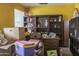 Bedroom with yellow walls, built-in shelving units, and window with blinds at 10603 W Ruth Ave, Peoria, AZ 85345