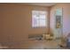 Bedroom showing window and sunflowers on wall and pillows, with view to bathroom at 10603 W Ruth Ave, Peoria, AZ 85345