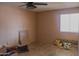 Simple bedroom with ceiling fan, natural light from the window, and decorative sunflower accents at 10603 W Ruth Ave, Peoria, AZ 85345