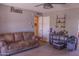 Living room with sofa, ceiling fan, and doorway to another room at 10603 W Ruth Ave, Peoria, AZ 85345