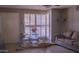 The living room features a sofa, shutters, neutral paint, and an exterior door at 10603 W Ruth Ave, Peoria, AZ 85345