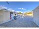 Large backyard featuring gravel landscaping, a covered patio, and ample space for outdoor activities and entertainment at 10917 W Apache St, Avondale, AZ 85323