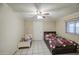 Bedroom with a double bed, a single bed, tiled floor, and ceiling fan at 10917 W Apache St, Avondale, AZ 85323