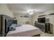 Spacious bedroom features a decorative headboard, ceiling fan, and tile flooring at 10917 W Apache St, Avondale, AZ 85323