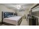The bedroom features a decorative headboard, ceiling fan, tile flooring, and ample storage at 10917 W Apache St, Avondale, AZ 85323