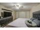 This bedroom features tile floors, ceiling fan, closet doors and a large dresser with TV at 10917 W Apache St, Avondale, AZ 85323