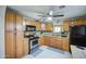 Bright kitchen featuring wooden cabinets, granite counters, and modern appliances at 10917 W Apache St, Avondale, AZ 85323