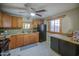 Kitchen showcasing wooden cabinets, granite countertops, and black appliances at 10917 W Apache St, Avondale, AZ 85323