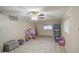 Tile floor, ceiling fan and natural light in this living area at 10917 W Apache St, Avondale, AZ 85323