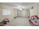 Spacious living room with tiled floor, neutral walls, and ceiling fan at 10917 W Apache St, Avondale, AZ 85323