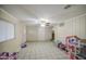 Living room featuring neutral walls, tiled floor, ceiling fan, and natural light at 10917 W Apache St, Avondale, AZ 85323