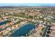 Aerial view showcasing the community, homes, nearby lake, and mature landscaping at 1101 N Peppertree Dr, Gilbert, AZ 85234