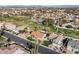 Aerial view of a well-maintained neighborhood with lush green spaces, mature trees, and a manicured landscape at 1101 N Peppertree Dr, Gilbert, AZ 85234