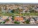 Aerial view of a home with a red tile roof, a manicured lawn, and a neighborhood park nearby at 1101 N Peppertree Dr, Gilbert, AZ 85234
