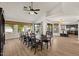 Spacious dining room with views to the back, connected to the kitchen, and a long table at 1101 N Peppertree Dr, Gilbert, AZ 85234