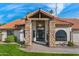 Inviting home featuring stone columns, a covered entryway, a decorative front door, and manicured landscaping at 1101 N Peppertree Dr, Gilbert, AZ 85234
