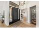 Inviting entryway with hardwood floors, stylish light fixture, and decorative accents at 1101 N Peppertree Dr, Gilbert, AZ 85234