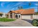 Lovely home featuring a red tile roof, stone accents, a well-manicured lawn, and mature landscaping at 1101 N Peppertree Dr, Gilbert, AZ 85234