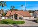 A single-story home boasting a red tile roof, stone accents, an attached garage, and manicured landscaping at 1101 N Peppertree Dr, Gilbert, AZ 85234