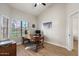 Office room with a wooden desk, a black rolling chair, and views to the outside at 1101 N Peppertree Dr, Gilbert, AZ 85234