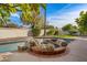 Relaxing pool area with a unique rock feature and lush greenery, perfect for outdoor enjoyment at 1101 N Peppertree Dr, Gilbert, AZ 85234